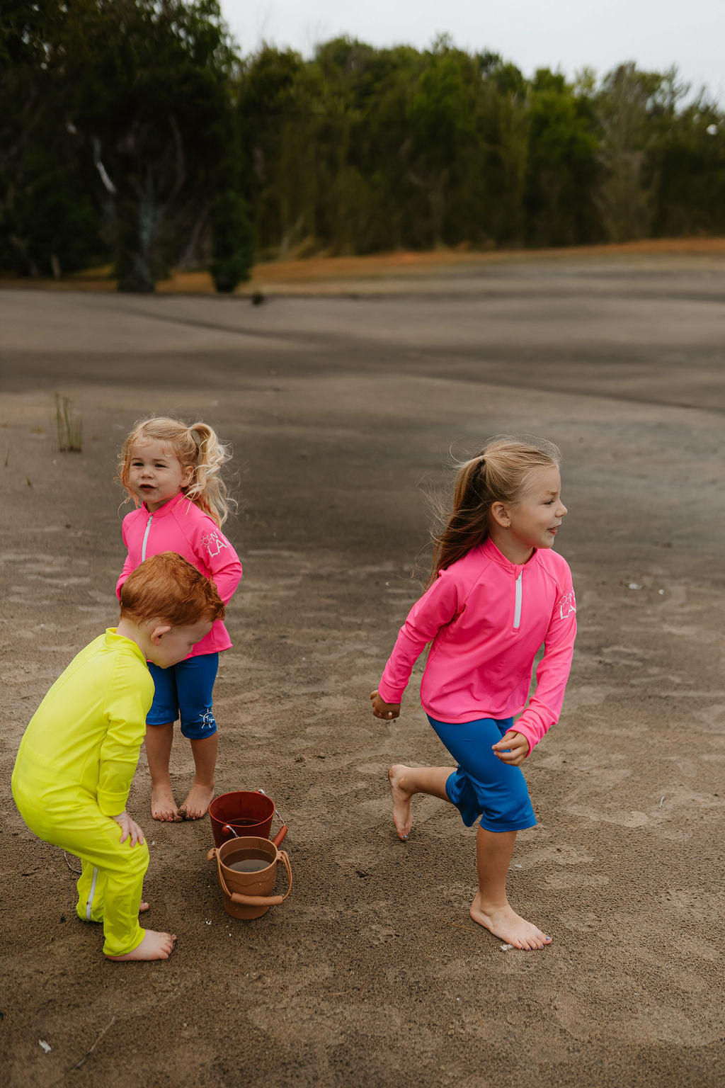 Girl blowing bubbles in bright green UV protective Sun Shirt and Shorts