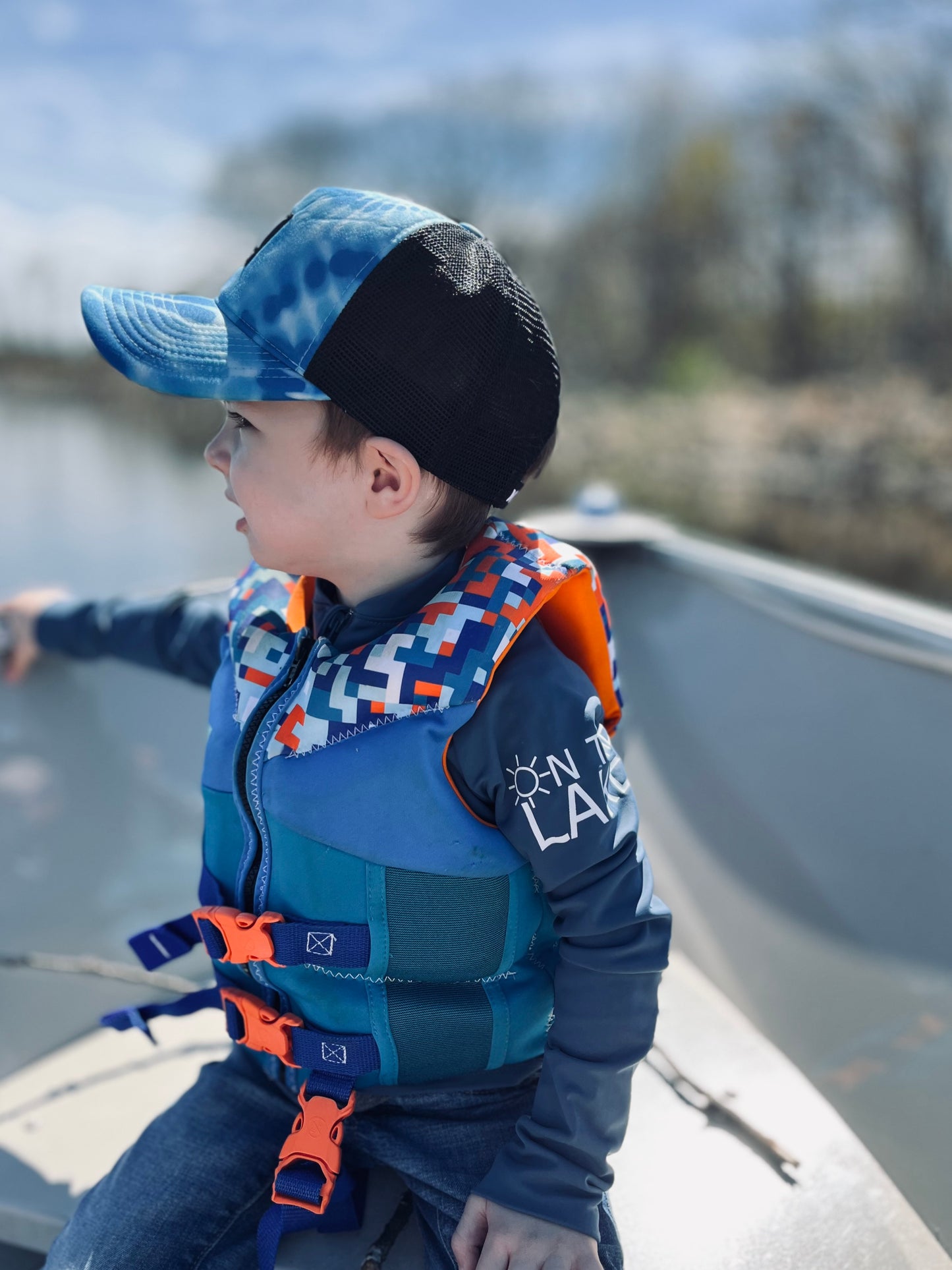 Kids UPF 50+ natural sun protection swimwear clothing Canada, UPF 50+ swimwear, Sun protective clothing, UV swimwear, Sun-safe apparel, UV protection for water activities, Sun-blocking swimwear, Family sun protection clothing, Sunsafe boating attire, little boy in boat with blue shirt