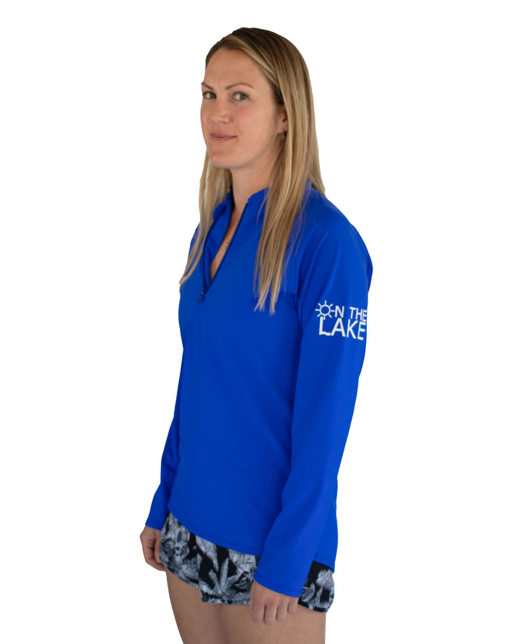 Adult UPF 50+ natural sun protection swimwear clothing Canada, UPF 50+ swimwear, Sun protective clothing, UV swimwear, Sun-safe apparel, UV protection for water activities, Sun-blocking swimwear, Family sun protection clothing, Sun safe boating attire, woman fishing in royal blue UPF 50+ shirt