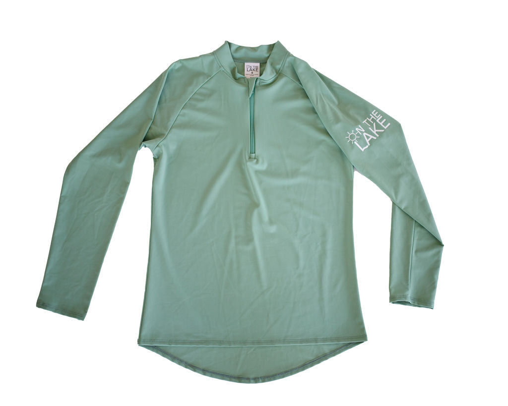 Adult UPF 50+ natural sun protection swimwear clothing Canada, UPF 50+ swimwear, Sun protective clothing, UV swimwear, Sun-safe apparel, UV protection for water activities, Sun-blocking swimwear, Family sun protection clothing, Sun safe boating attire, woman fishing in soft green UPF 50+ shirt