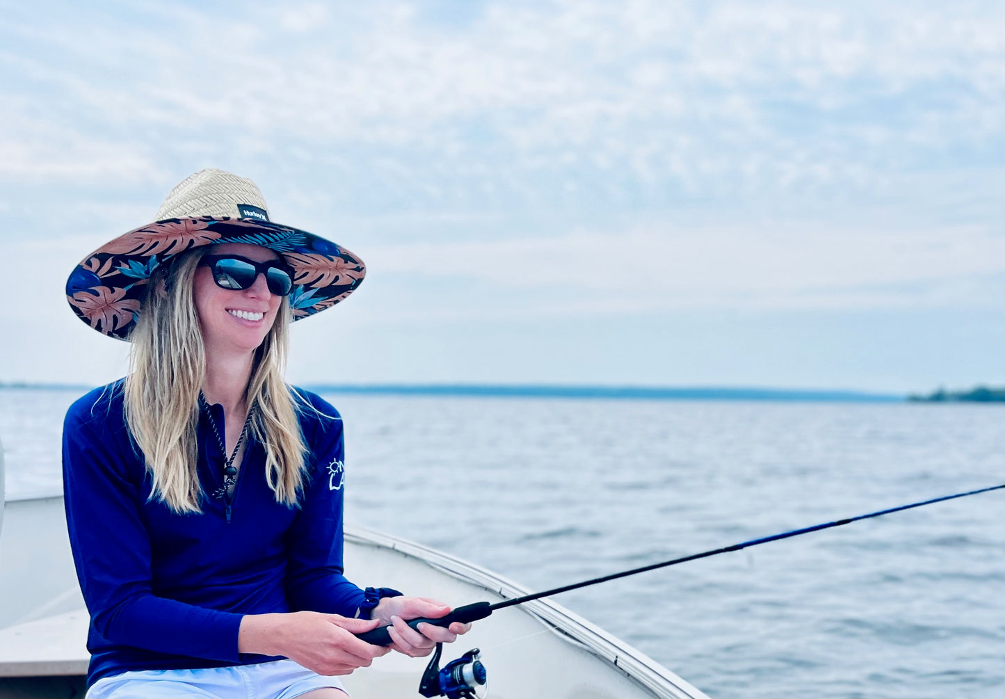 Adult UPF 50+ natural sun protection swimwear clothing Canada, UPF 50+ swimwear, Sun protective clothing, UV swimwear, Sun-safe apparel, UV protection for water activities, Sun-blocking swimwear, Family sun protection clothing, Sun safe boating attire, woman fishing in navy UPF 50+ shirt