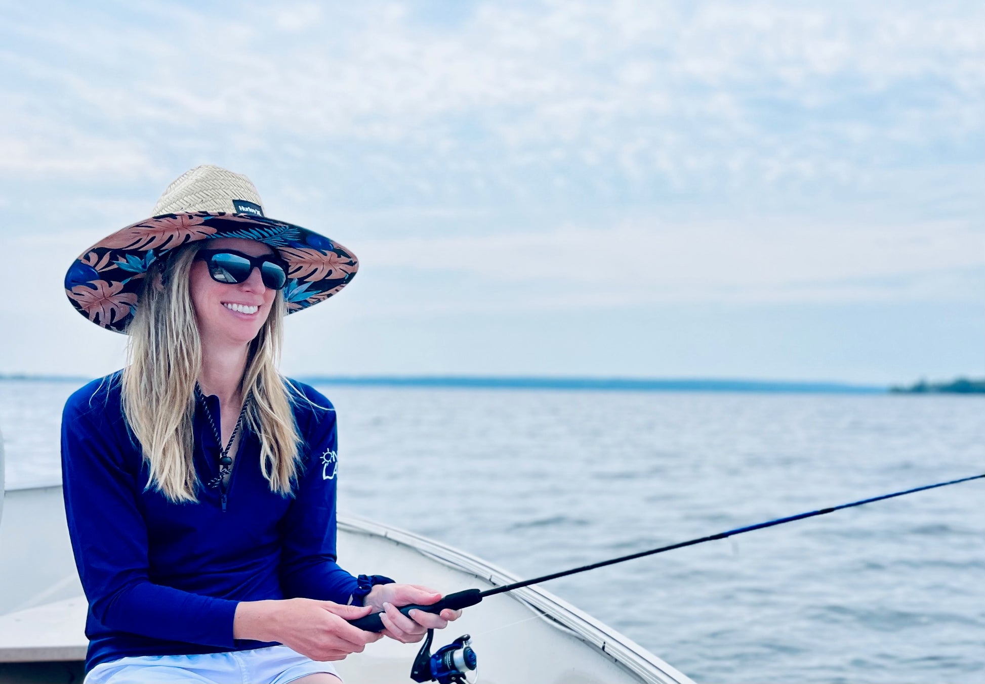 Adult UPF 50+ natural sun protection swimwear clothing Canada, UPF 50+ swimwear, Sun protective clothing, UV swimwear, Sun-safe apparel, UV protection for water activities, Sun-blocking swimwear, Family sun protection clothing, Sun safe boating attire, woman fishing in navy UPF 50+ shirt